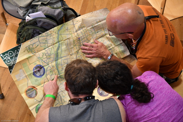 Three people looking at a map